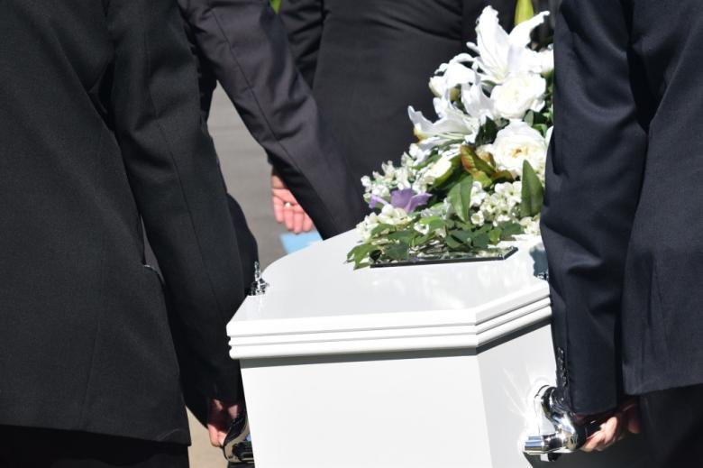 biała trumna niesiona podczas pogrzebu 