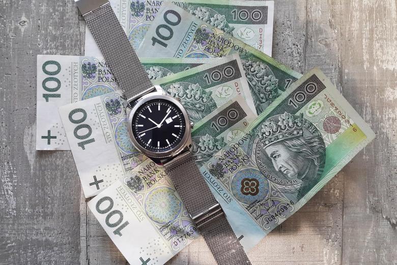 Zegarek ułożony na banknotach