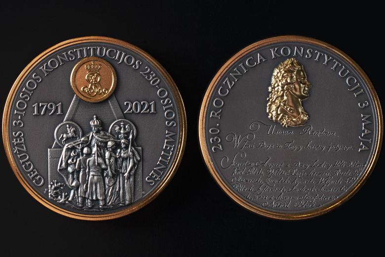 Zdjęcie przedstawiające awers i rewers medalu okolicznościowego w kolorze srebrnym ze złoceniami