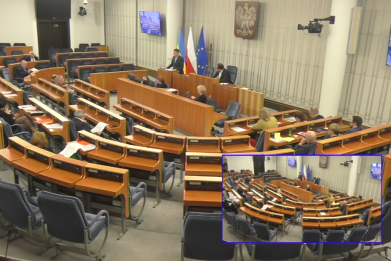 Zrzut ekranu z transmisji posiedzenia Komisji - ZRPO Wojciech Brzozowski wypowiada się z mównicy w sali plenarnej Senatu.
