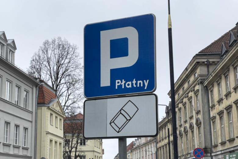 Prostokątny znak drogowy, na niebieskim tle duża litera "P" i napis "płatny"