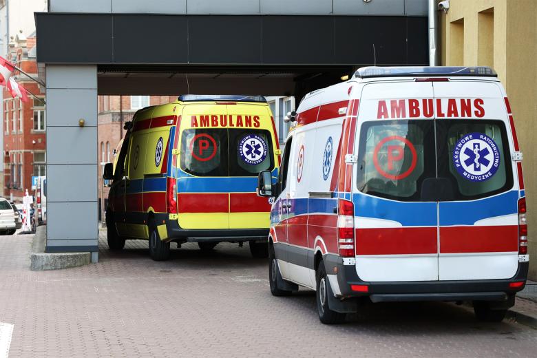 Dwie karetki stoją na podjeździe przed budynkiem