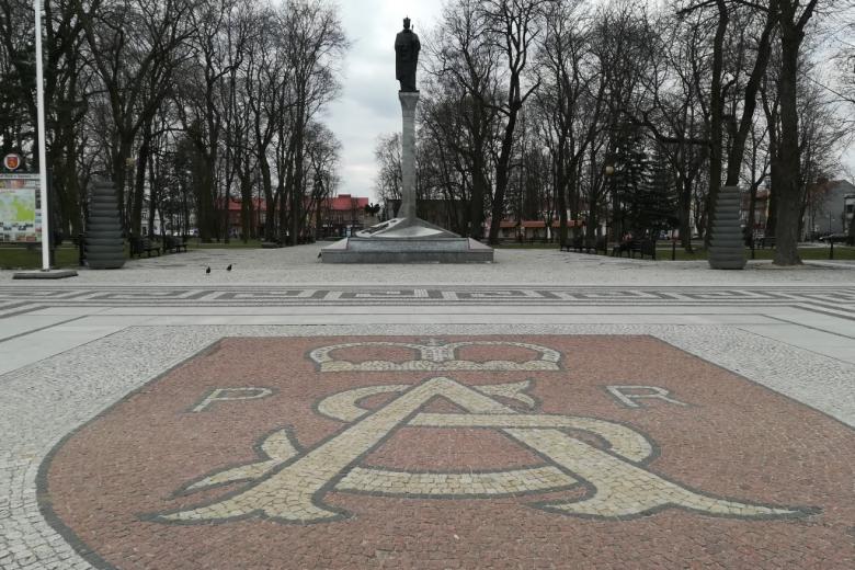Monogram SA na chodniku i pomnik króla na kolumnie