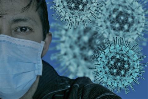 twarz człowieka w masce na tle wirusów