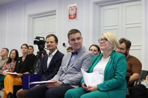 osoby siedzą w sali 