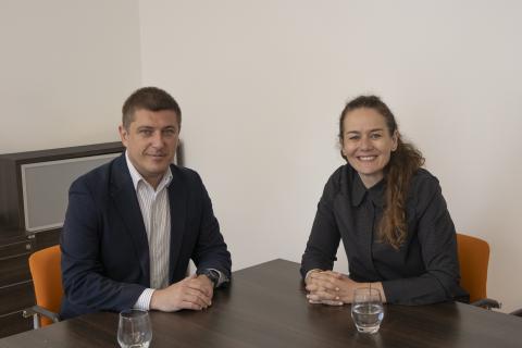 dwie osoby siedzą w sali